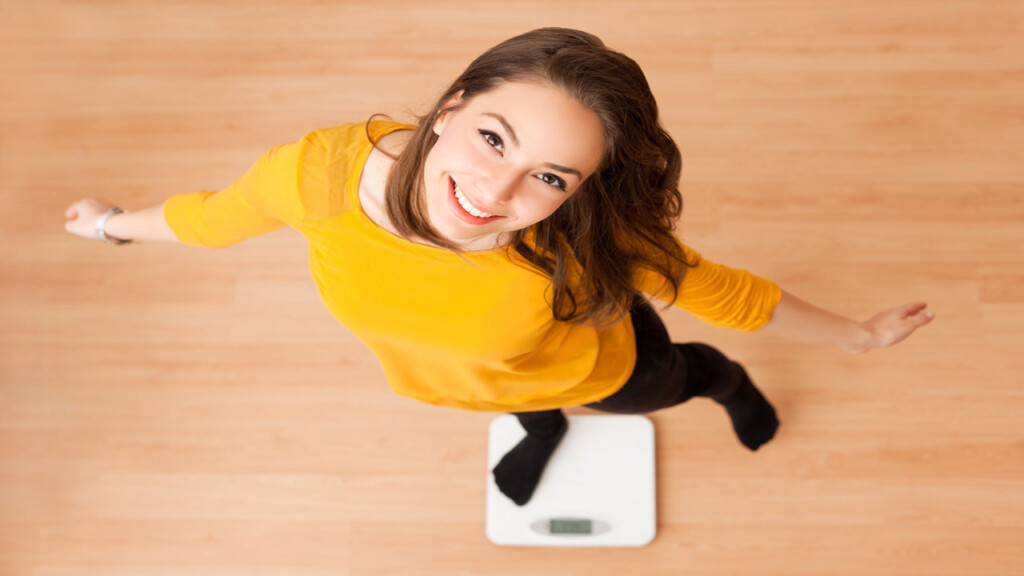 happy woman on scale