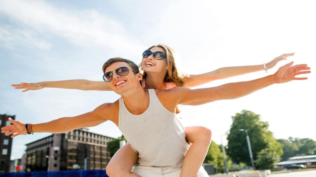 girl getting piggy back ride from man