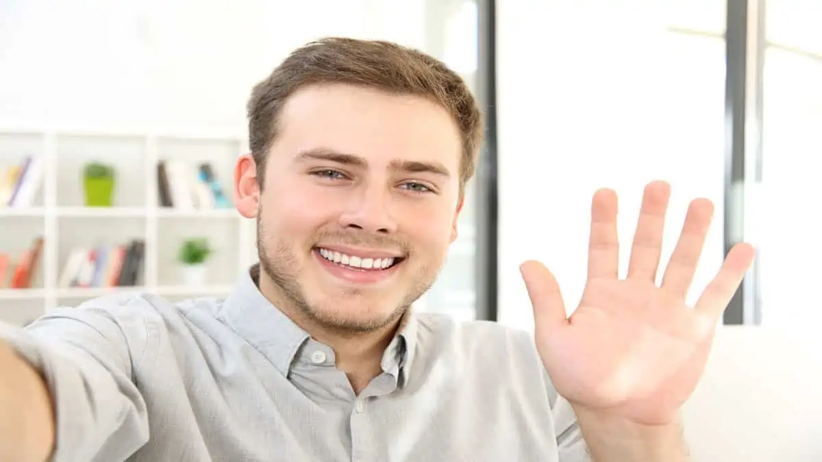 man smiling and waving