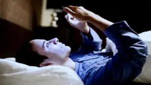 man-on-phone-in-bed