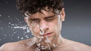 man-splashing-water-on-face